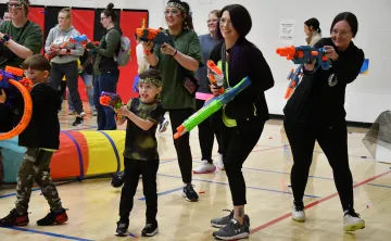 Mothers and Sons in a nerf war battle
